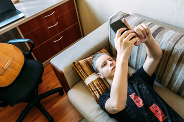 Digital Addiction in Tweens and Teens, smartphone addicted. Teenage boy playing online game,...