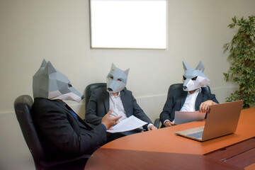 Group of business partners wearing wolf masks having a meeting in the office