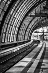 Vertical grayscale shot of a train station in Berlin, Germany