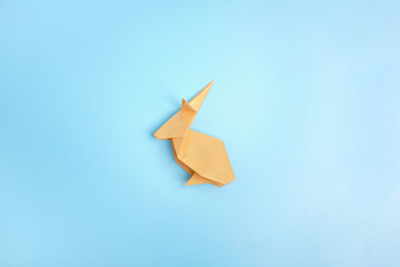 Origami Bunny. Step-by-step photo instruction on a blue background. Easter bunny. DIY concept...