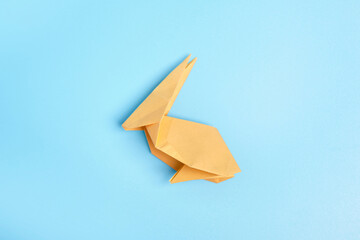 Origami Bunny. Step-by-step photo instruction on a blue background. Easter bunny. DIY concept Step14. Rabbit 2023