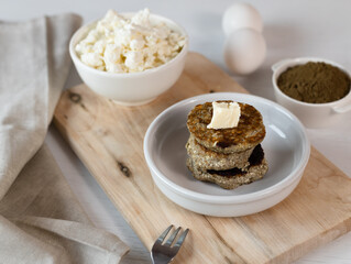 Syrniki, cottage cheese fritters or curd pancakes, made from curd and hemp flour. Low carb Ketogenic diet.