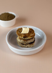 Syrniki, cottage cheese fritters or curd pancakes, made from curd and hemp flour. Low carb Ketogenic diet.