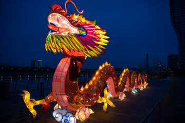 A huge colorful bright glowing chinese dragon Lun during the Chinese New Year celebration. Lantern...