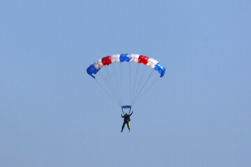 Skydiver flying wing in a blue sky