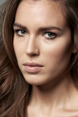 Fototapeta premium Beauty in simplicity. Cropped shot of a beautiful young woman against a gray background.