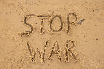 Stop war written on the sand on the banks of the Dnieper River in Ukraine, a protest