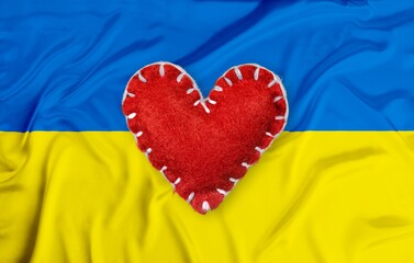 Ukrainian flag with heart. Concept love. Stop the war in Ukraine.