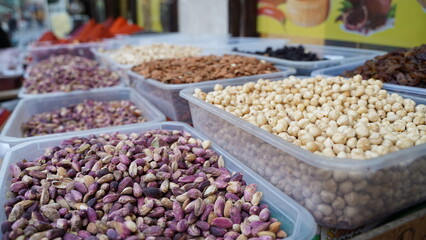 Pistachios and Hazelnuts in the Market, Blurred Nuts on the Background