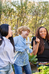 Fototapeta premium three women dance and laugh outdoors