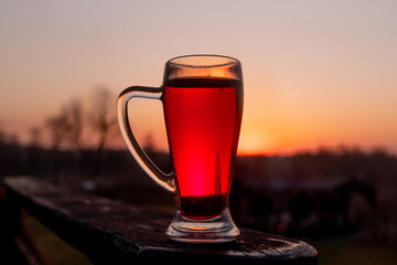 red alkoholic drink in a glass sunset background