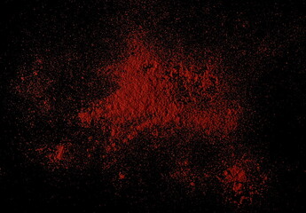 Fototapeta na wymiar Red paprika, pepper powder pile isolated on black, top view