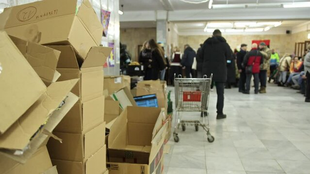 Logistics center for sending cargo in support of ukrainian soldiers in russia's war against ukraine. Lots of boxes of products from volunteers. Blurred background.