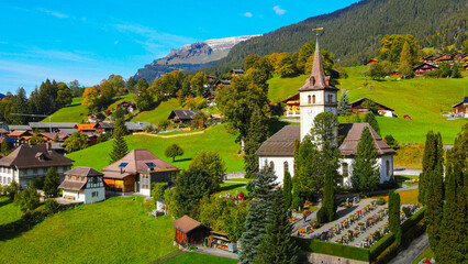 Famous city of Grindelwald in the Swiss Alps from above - drone footage - obrazy, fototapety, plakaty