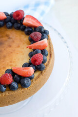 Half a pie with berries on a light background, top view. Food photo of the dessert
