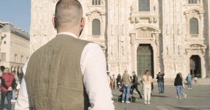 Young guy taking picture of Duomo, Milan, Italy
