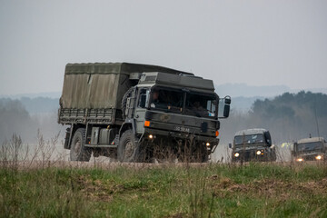 a small convoy British Army Land Rover Defender Wolf medium utility vehicles and a MAN SV 4x4...