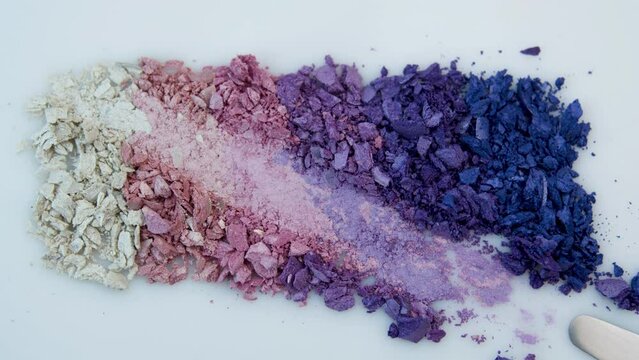 Texture of dry eye shadows of lilac, blue, pink and pearl shades. texture of eye shadows close-up. Advertising of decorative cosmetics.