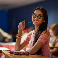 Im going to ace my exams. Portrait of a beautiful university student making notes while sitting in...