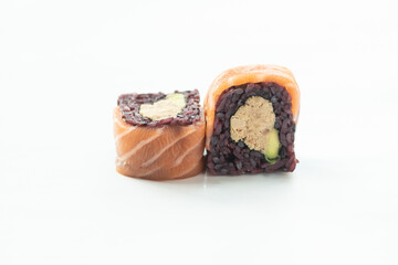 Sushi roll with black rice and salmon isolated Uramaki on white background maki