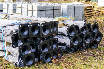 a stack of building materials with street lamp bases and lampposts packed for transport