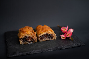 Baklava with prunes. Traditional Balkan dessert. Homemade baklava with prunes and honey. Eastern sweetness. Traditional Middle Eastern tastes. 