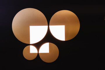 Four circles of different diameters and a light rectangle in the middle