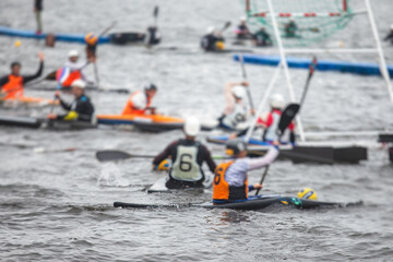 Canoe polo match, two teams play kayak polo game outdoor competition in the lake river, water sport
