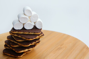 chocolate cookies and marshmallows on a wooden board. handmade chocolate dessert