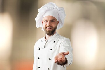Bearded male chef in white uniform. Chef in white uniform, chef hat.