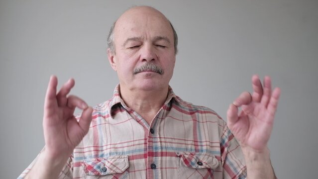 Handsome Senior Hispanic Man In Meditation Position