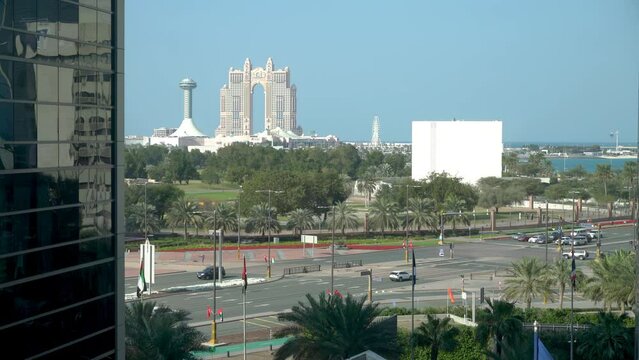 Abu Dhabi, United Arab Emirates - February 2022: Car traffic in Abu Dhabi city with Abu Dhabi skyline and Rixos Marina Hotel