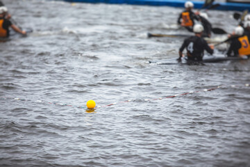 Canoe polo match, two teams play kayak polo game outdoor competition in the lake river, water sport
