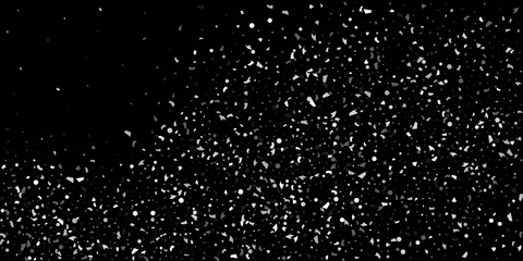 Silver grainy abstract texture overflows against a black background. Element of design.