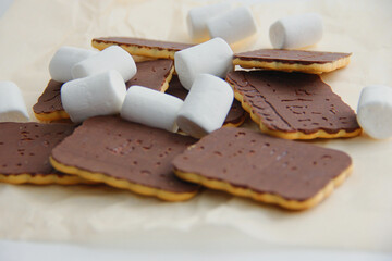 chocolate cookies and marshmallows on parchment paper. chocolate dessert