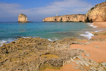 Fototapeta na wymiar Praia dos Caneiros Beach-sea stack, lighthouse and cliffs background. Ferragudo-Portugal-173
