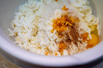 Homemade cow's cheese, ground, egg, homemade cheesecakes. Cheese in a bowl. Soft cheese in a white tall bowl. Selective focus