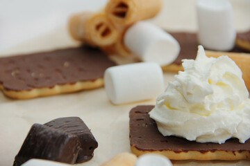 chocolate dessert with cream, chocolate sweets and waffles, cream cake among sweets.