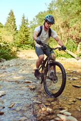 Fototapeta premium Cyclist Riding the Bike on the Trail in the Forest. Man cycling on enduro trail track. Sport fitness motivation and inspiration. Extreme Sport Concept. Selective focus
