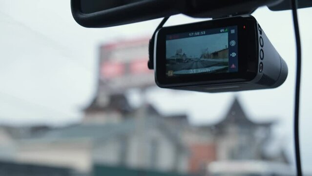 The DVR works in the car. Video recording of the traffic situation while driving. The car is moving along a busy highway