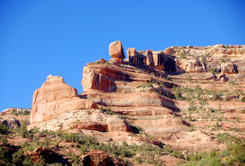 Red rock desert promontory and massive balancing rock overlooking Arch canyon in the Bears Ears wilderness area of Southern Utah.  