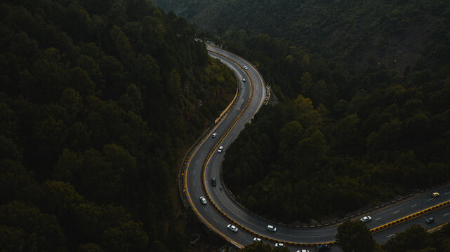 Aerial view of road in the middle of green mountains