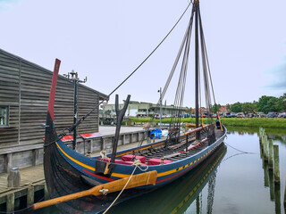 Beautiful shot of an Authentic ship of Vikings in Roskilde harbor Marina in Denmark with blue sky