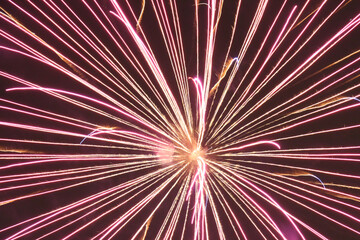Closeup shot of a beautiful firework  with pink and orange colors