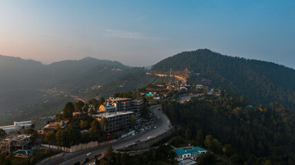 Aerial view of beautiful homes in green hills surrounded by trees