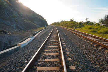 Fototapeta premium The railroad tracks pass through the grooved bearings buried under the shards of cobblestone