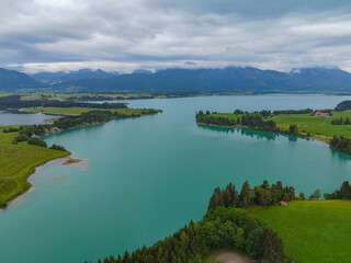 Obraz premium Aerial view over Lake Forggensee at the city of Fuessen in Bavaria Germany