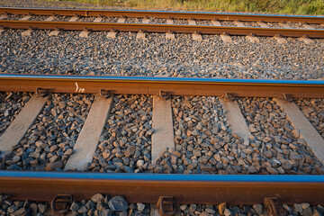 The railroad tracks pass through the grooved bearings buried under the shards of cobblestone