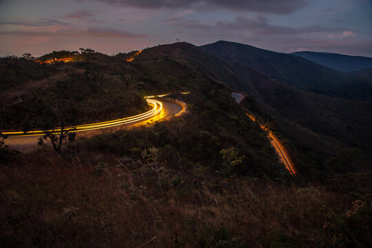 Light trail of cars traveling down the road in the mountains.
