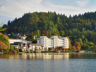 White building near the Bled Lake with a background of green forest